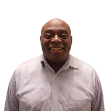 Smiling man in a light purple shirt against a white background.