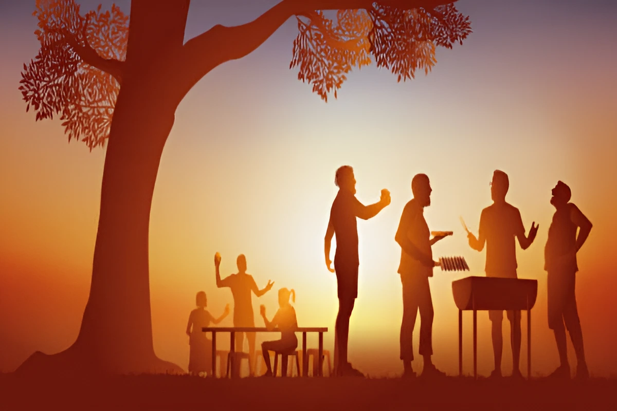 People enjoying a sunset barbecue in a park.