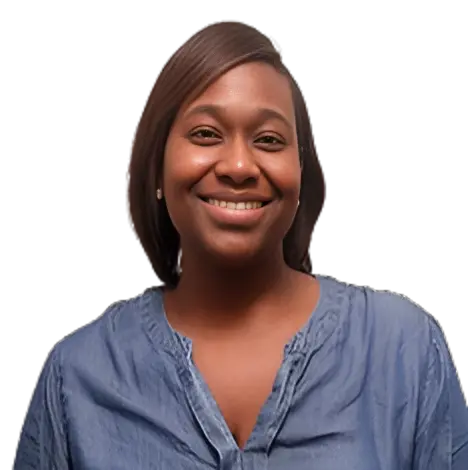 Smiling woman wearing a blue denim shirt.