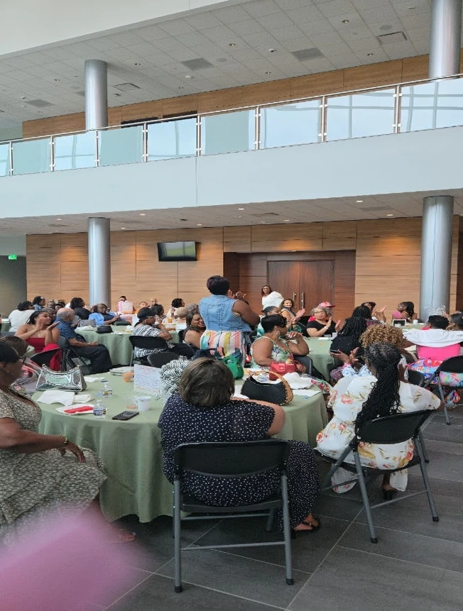 People gathered in a large hall for a communal event or meal.