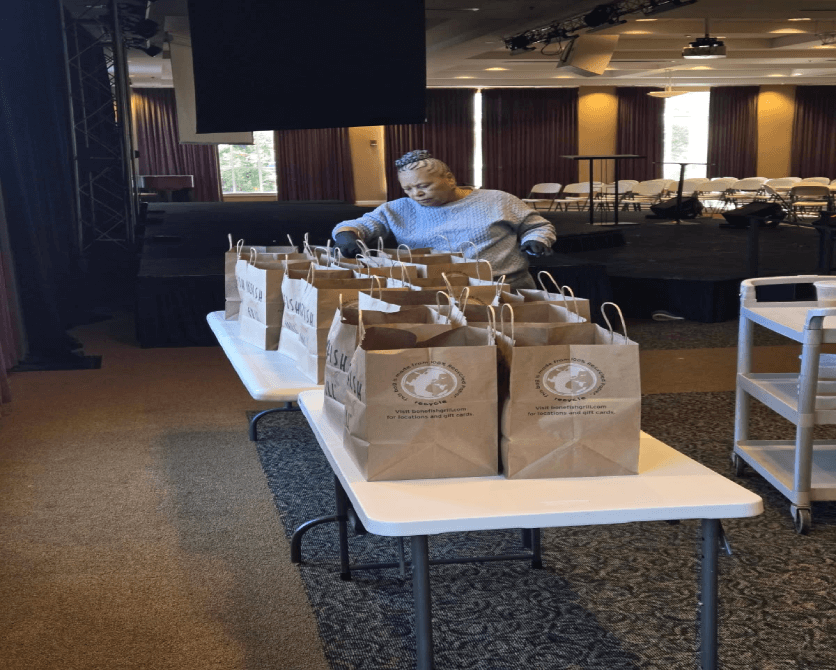 Person organizing bags on a table indoors.